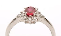 Lot 815 - A ruby and diamond cluster ring, the central...