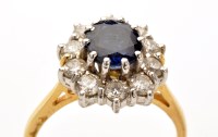 Lot 820 - A sapphire and diamond cluster ring, the...