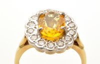 Lot 824 - A citrine and diamond cluster ring, the oval...