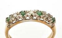 Lot 825 - An emerald and diamond ring, the four circular...