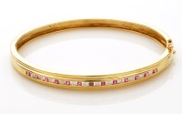 Lot 830 - A ruby and diamond bangle, the circular facet...