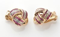 Lot 839 - A pair of ruby and diamond knot pattern...