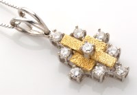 Lot 847 - A diamond and 18ct. yellow gold faced pendant,...