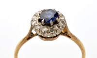 Lot 849 - A sapphire and diamond cluster ring, the...