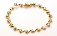 Lot 851 - A diamond and yellow metal bracelet, the...