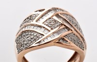 Lot 865 - A diamond set dress ring, of modern scrolling...