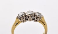 Lot 870 - A three stone diamond ring, the brilliant cut...