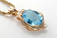 Lot 874 - A blue topaz and diamond pendant, the central...