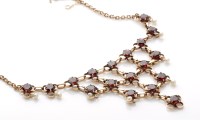 Lot 905 - A garnet and seed pearl fringe necklace, facet...