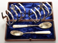 Lot 551 - A pair of George VI five bar toast racks, by...