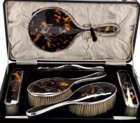 Lot 564 - A George V silver and tortoiseshell dressing...