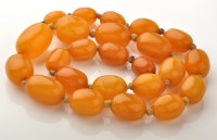 Lot 744 - A single row amber bead necklace, the...