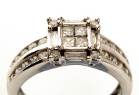 Lot 748 - A diamond ring, the central four princess cut...