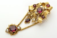 Lot 768 - A Victorian style garnet and pearl set bow...