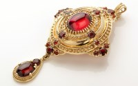 Lot 769 - A 9ct. yellow gold holbinesque ruby and garnet...