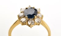 Lot 778 - A sapphire and diamond cluster ring, the...