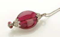 Lot 784 - A ruby and diamond brooch/pendant, the oval...