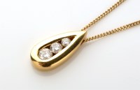 Lot 803 - A three stone diamond and 18ct. yellow gold...