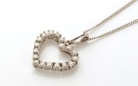 Lot 808 - A diamond set heart pattern pendant, set with...