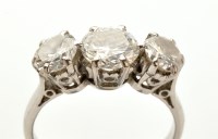 Lot 816 - A three stone diamond ring, the central stone...