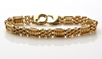 Lot 837 - A 9ct. yellow gold bracelet of gate and...