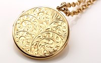 Lot 856 - A 9ct. gold circular locket pendant, the front...