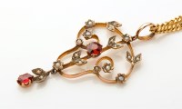 Lot 873 - An Edwardian garnet and seed pearl drop...