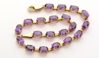 Lot 881 - An amethyst set 9ct. gold bracelet, the twenty...