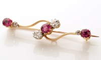 Lot 889 - An Edwardian ruby and diamond bar brooch, set...