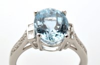 Lot 897 - An aquamarine and diamond ring, the oval facet...