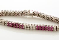 Lot 915 - A ruby and diamond double line bracelet, set...