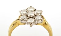 Lot 918 - A seven stone diamond cluster ring, the...