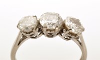 Lot 927 - A three stone diamond ring, the central...