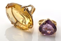 Lot 931 - Two gemstone dress rings, to include: an oval...