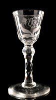 Lot 1009 - Engraved and cut faceted stem wine glass, the...