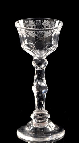 Lot 1012 - Engraved and cut faceted stem wine glass, the...
