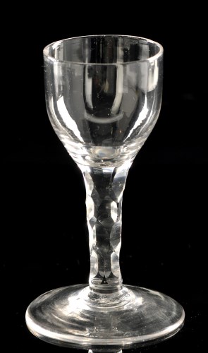 Lot 1023 - Faceted stem wine glass, the ogee bowl, on...