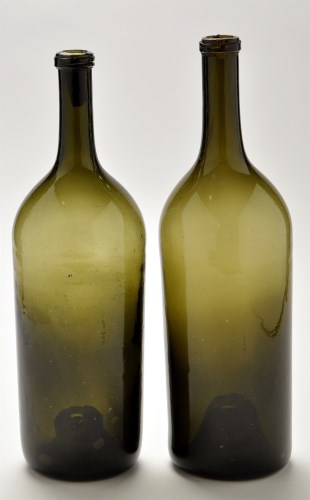 Lot 1028 - Two large green glass bottles, possibly 18th...