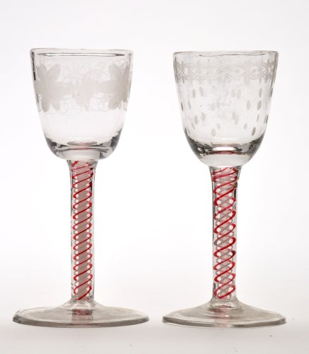 Lot 1036 - Two engraved opaque and red enamel twist wine...