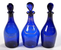 Lot 1057 - Three 'Bristol' blue glass decanters and...