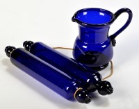 Lot 1059 - Two blue glass rolling pins, of typical form...