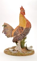 Lot 1194 - Porcelain figure of a cockerel, standing in an...