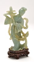 Lot 1285 - Celadon jade figure of a lady, her pose in...