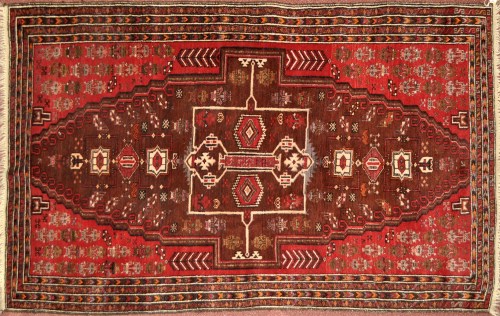 Lot 1307 - An Afgan Beluchi rug, floral motifs on red...