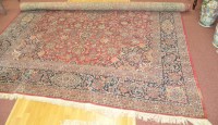 Lot 1317 - Kashan carpet, red ground with central...