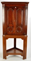 Lot 1399 - A late George III oak hanging corner cupboard,...