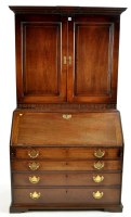 Lot 1400 - An early George III mahogany bureau bookcase,...