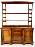 Lot 1401 - A George III oak breakfront dresser with open...