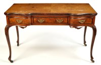 Lot 1431 - A Maple & Co. walnut veneered desk, the...