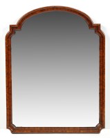 Lot 1470 - A wall mirror with arched moulded walnut frame,...